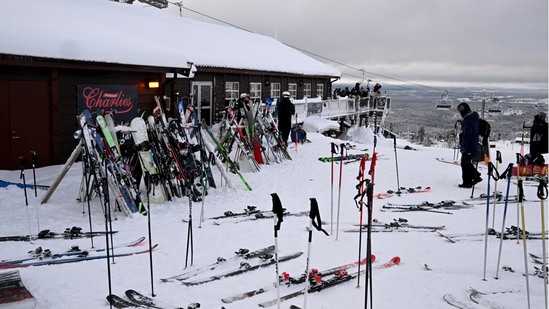 Skidåkare och skidor utanför Charlies restaurang i Idre Fjäll
